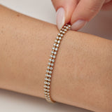 305 stainless steel tennis bracelet, 14K gold pvd coating with clear cubic zirconia.|BEI097