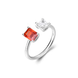 925‰ rhodium-plated sterling silver ring with clear square cubic zirconia and orange color baguette cubic zirconia.